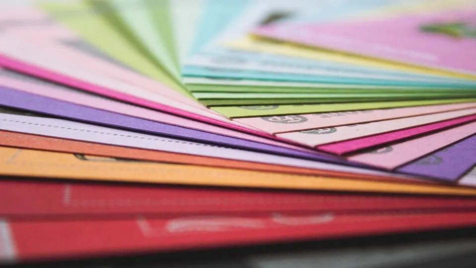 Leque de amostras de papel colorido sobrepostas, em close