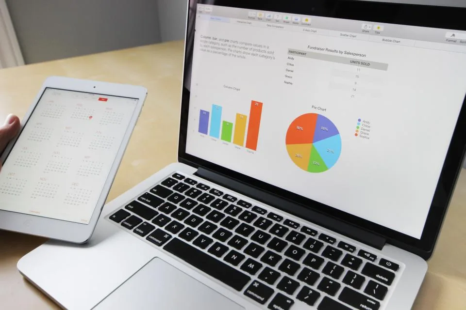 Mesa de trabalho com notebook aberto, usada como fundo do topo do artigo